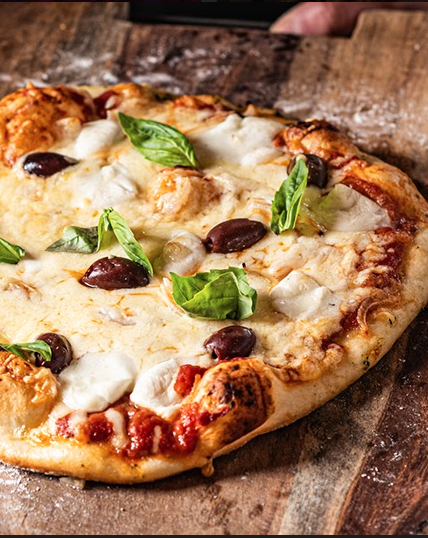 An artisinal pizza on a cutting board.