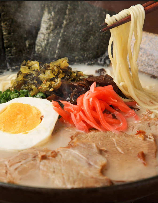 A hot bowl of ramen with toppings.